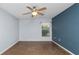 Comfortable bedroom with a ceiling fan, tile flooring, and natural lighting at 8904 Pebblebrooke Dr, Lakeland, FL 33810