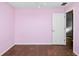 Bedroom featuring tile floor and a white door; room has been painted pink at 8904 Pebblebrooke Dr, Lakeland, FL 33810
