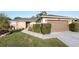 Home exterior boasting a well-kept lawn, established landscaping, and a convenient two-car garage at 8904 Pebblebrooke Dr, Lakeland, FL 33810