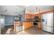 Updated kitchen with stainless steel appliances, brown cabinets, and an open layout at 8904 Pebblebrooke Dr, Lakeland, FL 33810