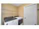 Laundry Room with a modern white washer and dryer and metal shelving at 8904 Pebblebrooke Dr, Lakeland, FL 33810