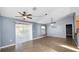 Open-concept living room boasting tile floors, vaulted ceilings, and natural light from sliding glass doors at 8904 Pebblebrooke Dr, Lakeland, FL 33810