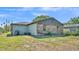 Backyard with lush grass, partial brick facade and ample space at 1017 Fleming Ave, Lakeland, FL 33815