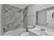 The bathroom features granite-look walls, a shower-tub combo, white fixtures, and a sink at 1017 Fleming Ave, Lakeland, FL 33815