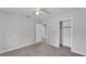 This bedroom features neutral carpet, neutral walls, a ceiling fan and a spacious closet at 1017 Fleming Ave, Lakeland, FL 33815