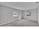 Bedroom featuring neutral colors, carpet and two windows at 1017 Fleming Ave, Lakeland, FL 33815