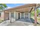 Covered carport featuring dual doors, brick siding, and natural light at 1017 Fleming Ave, Lakeland, FL 33815