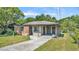 Charming single-story brick home with a covered carport and a well-maintained front yard at 1017 Fleming Ave, Lakeland, FL 33815