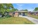 Charming single-story brick home with a covered carport and a well-maintained front yard at 1017 Fleming Ave, Lakeland, FL 33815