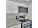 The kitchen offers stainless steel appliances, white cabinets, and granite countertops at 1017 Fleming Ave, Lakeland, FL 33815
