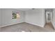 Bright, empty living room with neutral walls, window view, and neutral flooring at 1017 Fleming Ave, Lakeland, FL 33815