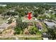 Aerial view of the house, surrounding trees and a storage shed in the backyard at 111 E Orange St, Davenport, FL 33837