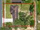 Aerial view of the house showing the roof, yard, trees, and driveway at 111 E Orange St, Davenport, FL 33837