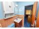 Compact bathroom features cabinet, mirror, and coordinated blue and peach tile at 111 E Orange St, Davenport, FL 33837