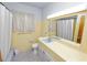 Bathroom features a yellow tile, patterned floor, bathtub and shower combo at 111 E Orange St, Davenport, FL 33837