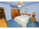 Tranquil bedroom with blue walls, floral bedding, wood furnishings, and a cozy vintage ambiance at 111 E Orange St, Davenport, FL 33837