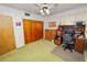 Bedroom setup with a desk, storage, and a closet with sliding doors at 111 E Orange St, Davenport, FL 33837