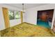 Well-lit dining area with window views and vintage green carpet at 111 E Orange St, Davenport, FL 33837