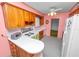 Cozy kitchen with wood cabinets, white countertops, vintage appliances, and a vintage feel, perfect for updates at 111 E Orange St, Davenport, FL 33837