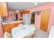 Eat-in kitchen with wood cabinets, appliances, and a table, creating a warm and inviting retro space at 111 E Orange St, Davenport, FL 33837