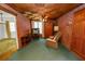 Retro living room featuring brick walls, a wood ceiling, and green carpet, creating a unique, vintage space at 111 E Orange St, Davenport, FL 33837