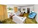 Inviting living room with floral couches and blue seating, complemented by a large window and natural lighting at 111 E Orange St, Davenport, FL 33837