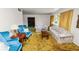 Bright living room featuring floral sofas, blue chairs, and a window with natural light at 111 E Orange St, Davenport, FL 33837
