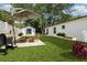 Backyard scene with outdoor table set, grill, and bench seating perfect for entertaining and relaxing at 113 Patrick Henry Rd, Bartow, FL 33830