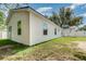 Back of house, white siding with ample windows and a grass yard at 113 Patrick Henry Rd, Bartow, FL 33830