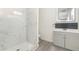 Bathroom featuring updated vanity, sleek fixtures, modern shower, and wood-look flooring at 113 Patrick Henry Rd, Bartow, FL 33830
