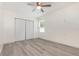 This bedroom features wood-look flooring and ample closet space, along with a bright window at 113 Patrick Henry Rd, Bartow, FL 33830