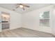 Bright bedroom with wood-look flooring, ceiling fan and an ensuite bathroom with neutral finishes at 113 Patrick Henry Rd, Bartow, FL 33830