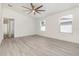 Bright bedroom features neutral walls, a ceiling fan, and two windows letting in natural light at 113 Patrick Henry Rd, Bartow, FL 33830
