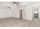 A bedroom featuring wood-look flooring, two ceiling fans, and an ensuite bathroom at 113 Patrick Henry Rd, Bartow, FL 33830