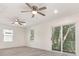 Bedroom featuring wood-look flooring, natural light, and two ceiling fans at 113 Patrick Henry Rd, Bartow, FL 33830