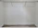 Empty closet with a wire shelf and light gray, wood-look flooring at 113 Patrick Henry Rd, Bartow, FL 33830