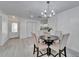 Bright dining area with modern chandelier and seating for four at 113 Patrick Henry Rd, Bartow, FL 33830