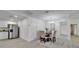 Open concept dining area with a modern chandelier, light walls, and luxury vinyl flooring at 113 Patrick Henry Rd, Bartow, FL 33830
