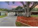 Charming one-story home with a welcoming porch and landscaped front yard featuring a beautiful mature shade tree at 113 Patrick Henry Rd, Bartow, FL 33830