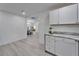 Hallway with bright walls and luxury vinyl flooring leading into other rooms in the home at 113 Patrick Henry Rd, Bartow, FL 33830