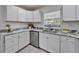 Updated kitchen featuring stainless dishwasher, white cabinets, and grey countertops at 113 Patrick Henry Rd, Bartow, FL 33830