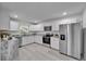 Bright kitchen with stainless steel appliances, stone countertops, and white cabinets at 113 Patrick Henry Rd, Bartow, FL 33830