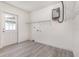 Bright laundry room featuring a water heater, shelving, and an exterior access door at 113 Patrick Henry Rd, Bartow, FL 33830