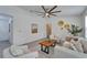 Elegant living space showcasing modern artwork, comfortable seating, and stylish ceiling fan at 113 Patrick Henry Rd, Bartow, FL 33830