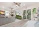 Bright living room with two ceiling fans, a glass sliding door and neutral color palette at 113 Patrick Henry Rd, Bartow, FL 33830