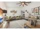 Staged living room features modern decor, a stylish rug, comfortable seating, and wood-look flooring at 113 Patrick Henry Rd, Bartow, FL 33830