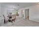 Open concept living area with dining area, luxury vinyl flooring, and neutral walls at 113 Patrick Henry Rd, Bartow, FL 33830