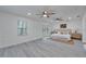 Bright main bedroom with sliding door access to the yard, modern ceiling fans, and backyard views at 113 Patrick Henry Rd, Bartow, FL 33830