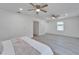 Well-lit main bedroom offering ample space, dual ceiling fans, and a convenient ensuite bathroom at 113 Patrick Henry Rd, Bartow, FL 33830
