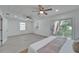 Expansive main bedroom featuring dual ceiling fans, slider access to the yard, and bright, neutral finishes at 113 Patrick Henry Rd, Bartow, FL 33830